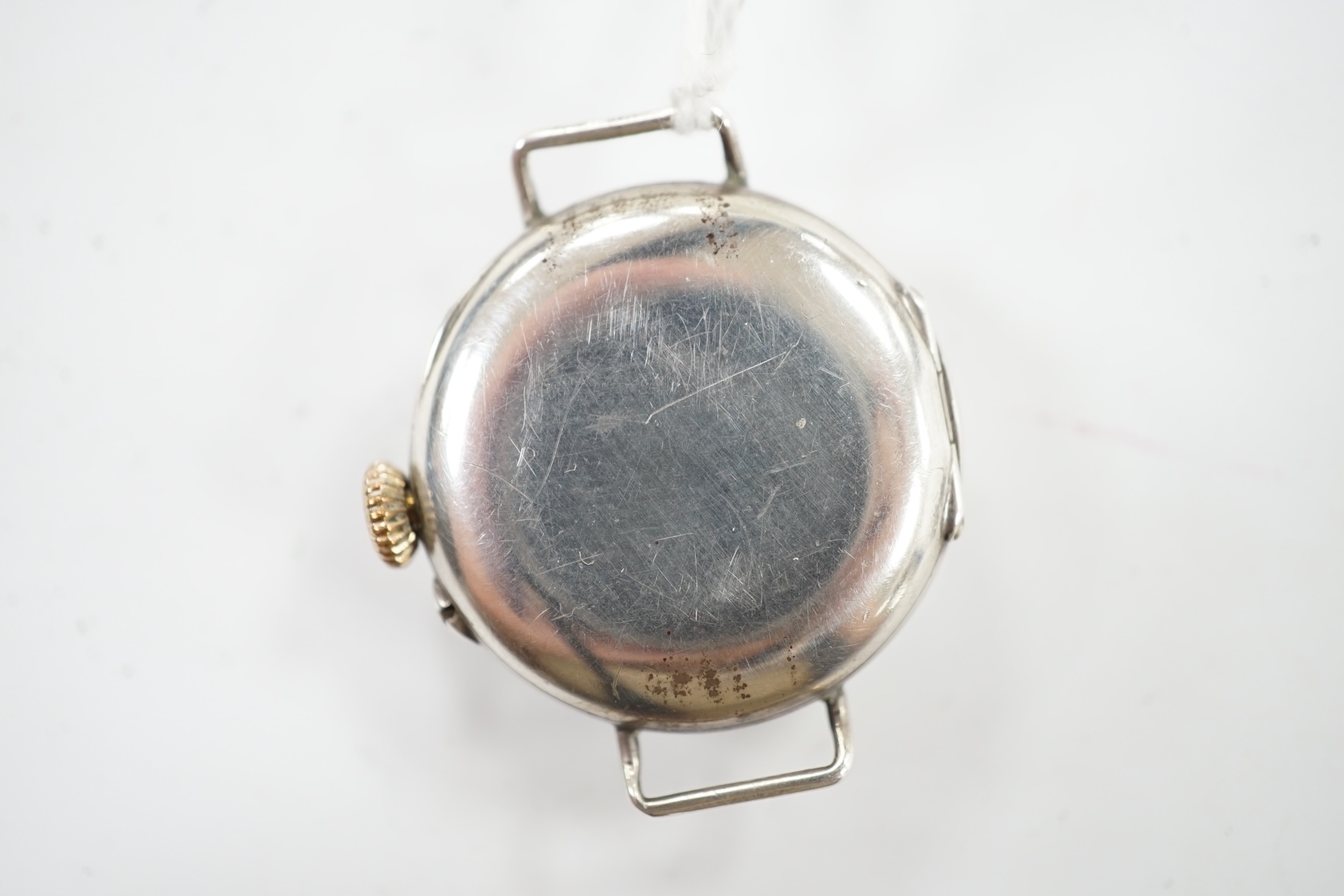 A George V silver manual wind wrist watch, with Arabic dial, no strap. Condition - poor